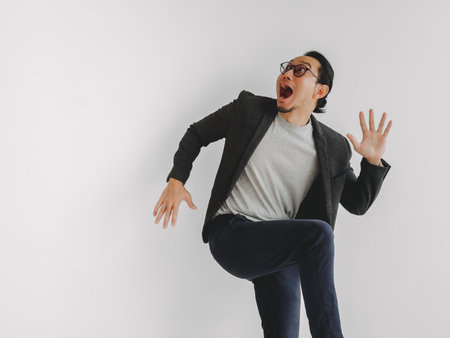Half body photo of funny exciting and surprise Asian business man on white.の写真素材