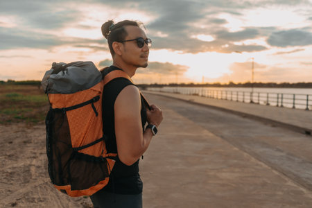 Asian man tourist backpacker has a sightseeing at the river.