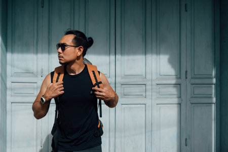 Asian tourist backpacker man waiting in Asia old town.の写真素材