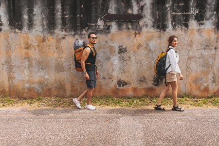 Asian couple tourist backpacker walking along the street in Asia old town.の写真素材