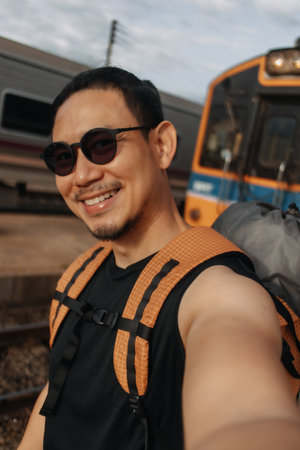 Asian man tourist backpacker selfie himself with the train in Asia.の写真素材