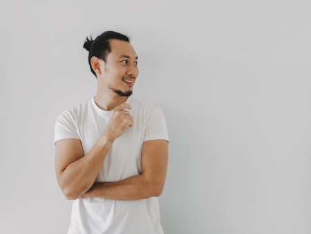 Smile happy Asian man looking at the empty content isolate on white.の写真素材