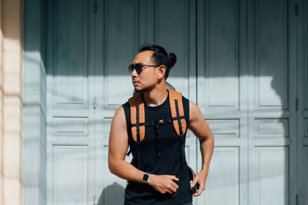 Asian tourist backpacker man waiting for taxi in Asia old town.の写真素材