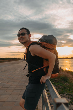 Asian man tourist backpacker has a sightseeing at the river.