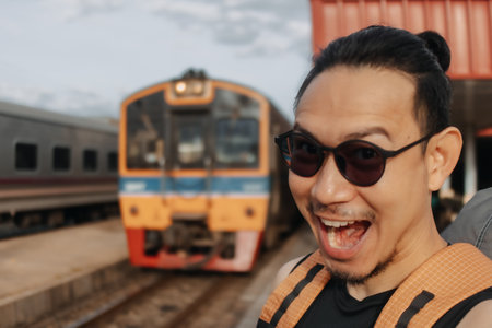 Asian man tourist backpacker selfie himself with the train in Asia.の写真素材