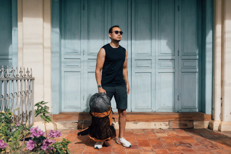 Asian tourist backpacker man waiting in Asia old town.の写真素材