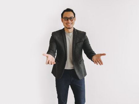 Half body photo of Asian business man offer and suggest empty product on white.の写真素材