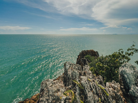 Scenic tropical shoreline with clear ocean water and rocky cliffsの写真素材