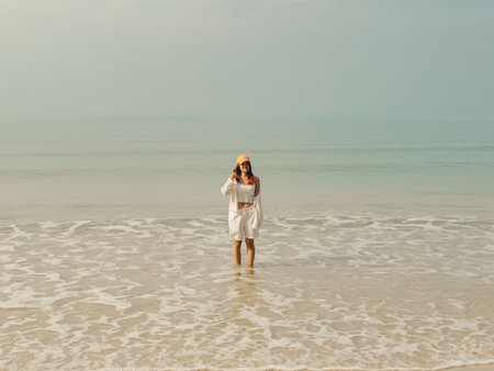 Asian woman relaxed on the beach with clear water in sunny day, Thailand.の写真素材
