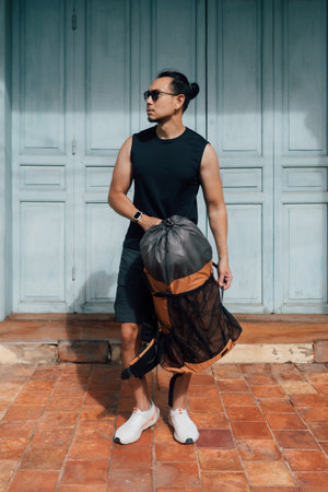 Asian tourist backpacker man waiting for taxi in Asia old town.の写真素材