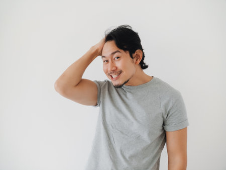 A cheerful and happy young man is in a playful pose, effectively showcasing his confidence and pure joyの写真素材