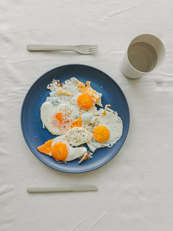 A vibrant and colorful breakfast scene featuring perfectly fried eggs, ideal for food blogs and...