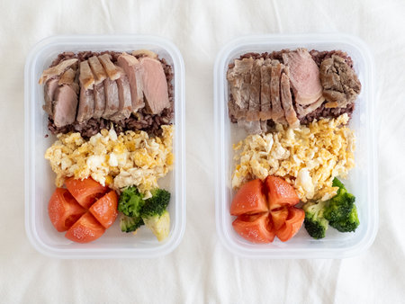 Balanced meal preparation that includes lean meats, fresh vegetables, ensuring nutrition and convenienceの写真素材
