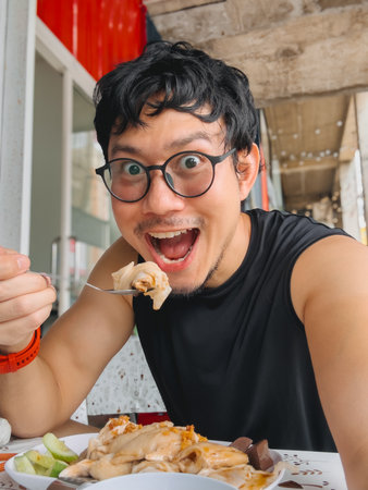 A joyful person delighting in a delicious meal, showcasing their passion for food within a vibrant atmosphereの写真素材