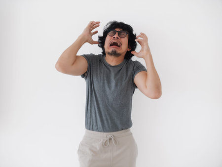 asian man man distressed emotionally, asian male experiencing intense emotional struggle and...