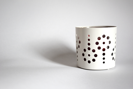 Decorated white container with holes on a white backgroundの写真素材