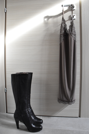 Fashion babydoll and boots on a sunlit doorの写真素材