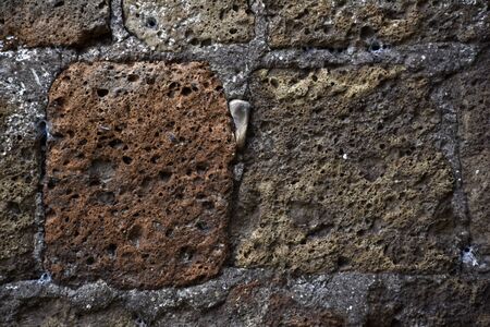 Texture Tuff stone wall brown grayの写真素材