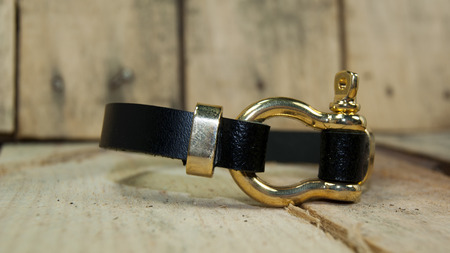 black leather  men bracelet ,wristband over boardの写真素材
