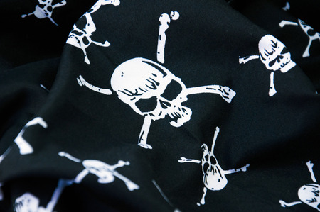 Black pirate flag with skull symbolsの写真素材