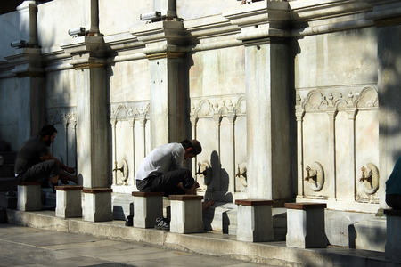 Istanbul, Turkey - September 15, 2015: People pray at the mosque they ritually washing before.のeditorial素材