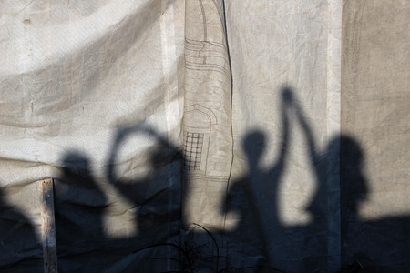 The shadow of humans on white cloth.の写真素材