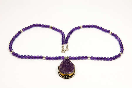 Close-up purple color handmade necklace isolated by white backgroundの写真素材