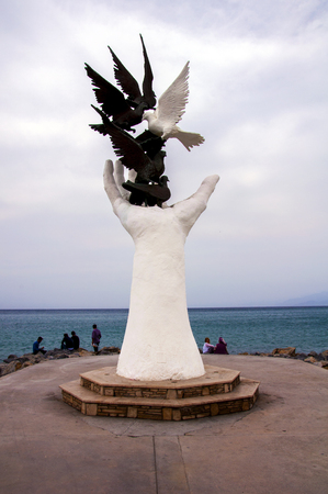 Unidentified Turkish people relax around the Hand of Peace Monument in Kusadasi, Aegean Coast, Turkeyのeditorial素材
