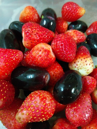 Full of Strawberries and Black Grapeの写真素材