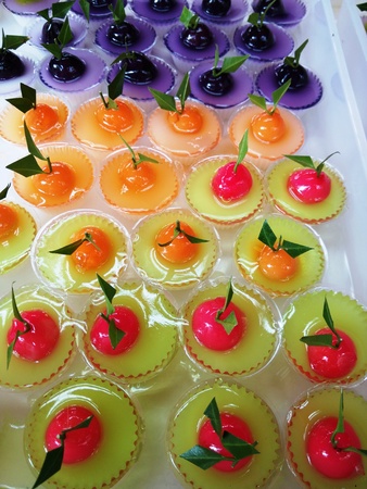 Colorful of Thai Sweet Bean Confections plating in Coconut Sweet Pudding Jelly (Thai Dessert of Kanom Look Choup nai Wun Kati)の写真素材