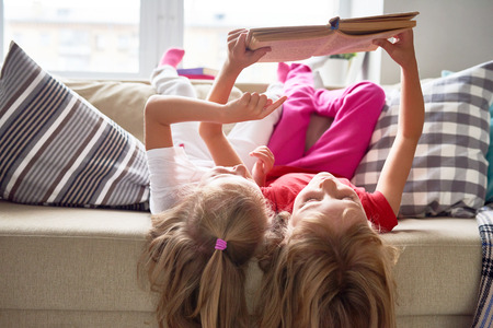 Little Girls Reading Book at Homeの写真素材
