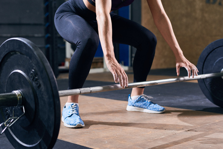 Beautiful Woman Lifting Heavy Barbellの写真素材