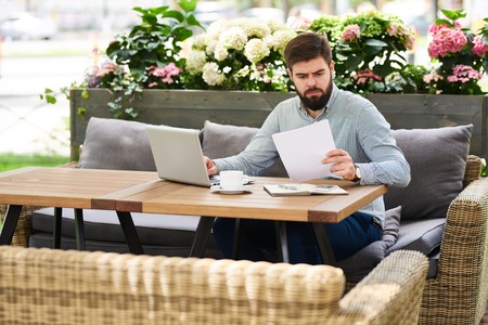 Modern Entrepreneur Working in Cafe Outdoorsの写真素材
