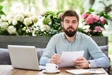 Bearded Entrepreneur Working in Outdoor Cafeの写真素材