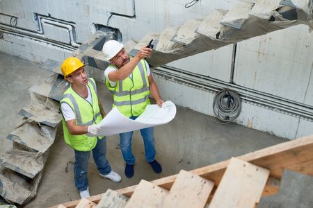 Construction Supervisor Discussing Building Plansの写真素材