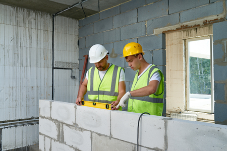Construction Workers Building Wallの写真素材