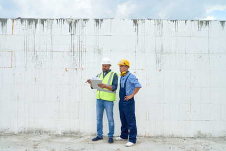 Construction Workers Discussing Buildingの写真素材