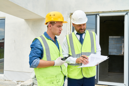 Construction Supervisor Talking to Workerの写真素材
