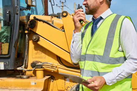 Construction Foreman Giving Instructions by Radioの写真素材