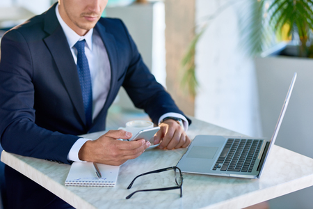 Modern Businessman Holding Smartphoneの写真素材