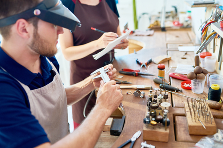 Portrait of young man and woman  in workshop studioの写真素材