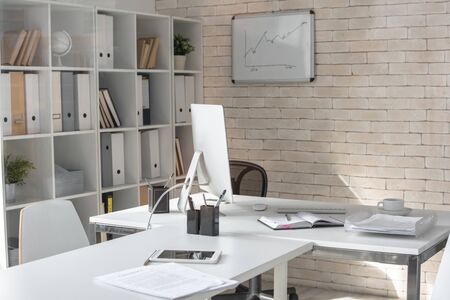 Background image of empty modern office in white color with desk and computer on itの写真素材