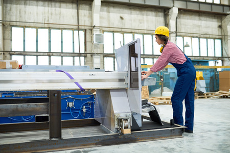 Woman working on plasma cutting equipment