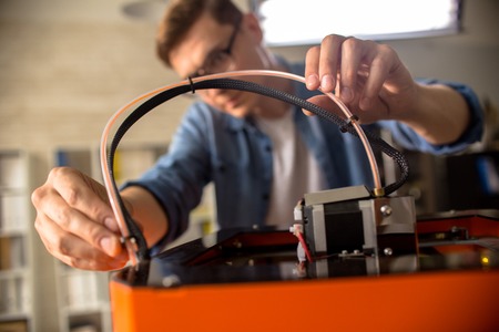 Young Man Connecting 3D Printer