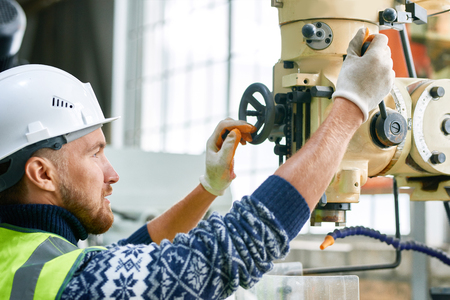 Factory Worker Using Machine Units