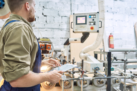 Worker Using Modern Machine at Factory
