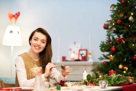 Attractive Woman Making Christmas Decorationの写真素材