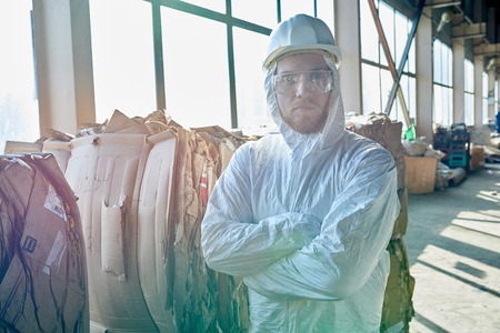 Worker Posing in Sunlight at Modern Waste Processing Plant
