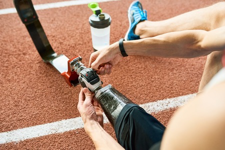Handicapped Sportsman Fixing Artificial Limbの写真素材