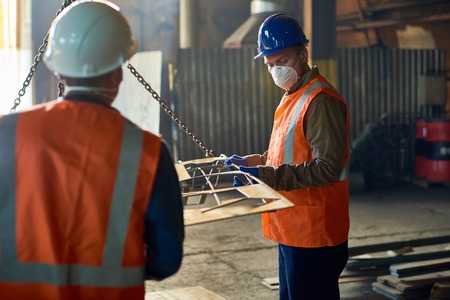 Factory Workers Using Lifting Beamの写真素材